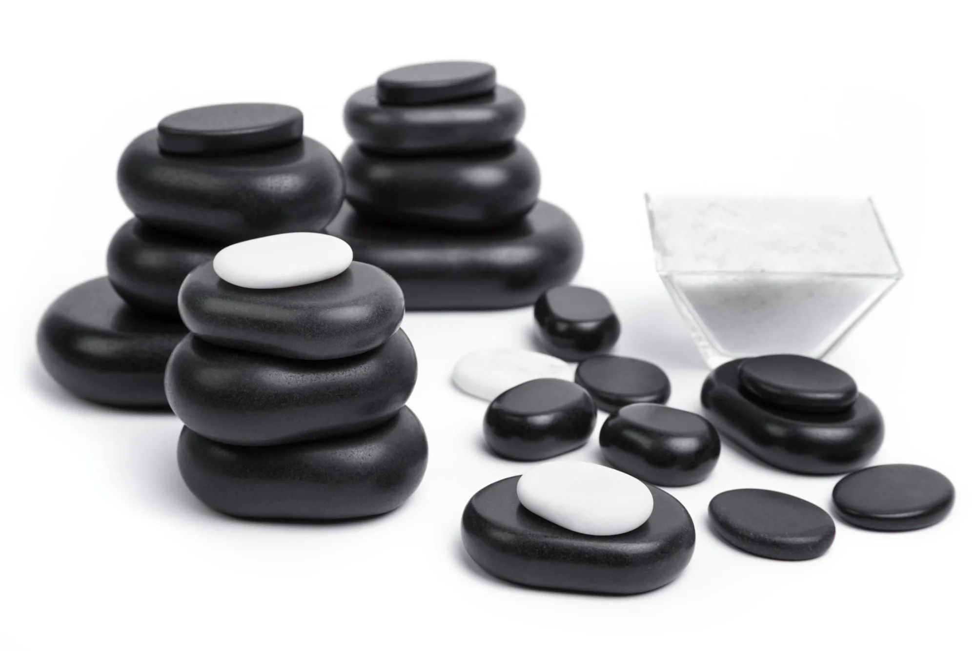 Smooth massage stones on a white surface